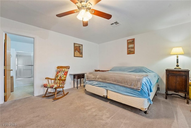 carpeted bedroom with ensuite bathroom and ceiling fan