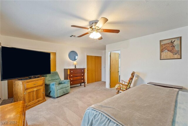 bedroom with ceiling fan and light colored carpet