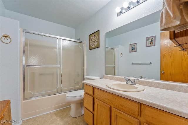 full bathroom featuring vanity, enclosed tub / shower combo, a textured ceiling, and toilet