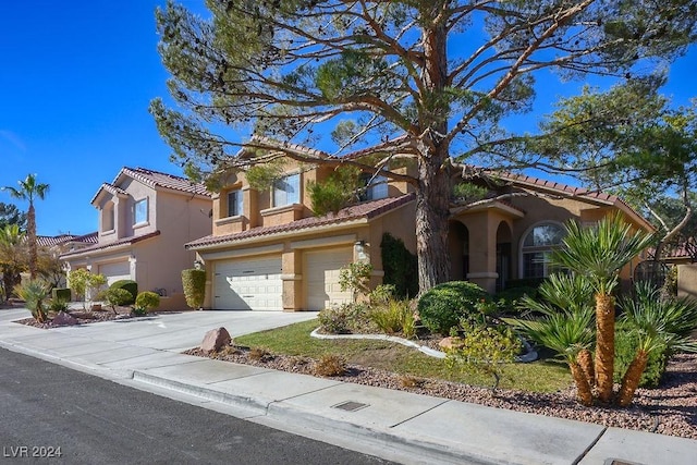 mediterranean / spanish house with a garage