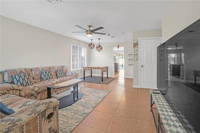 living room featuring light tile patterned floors and ceiling fan