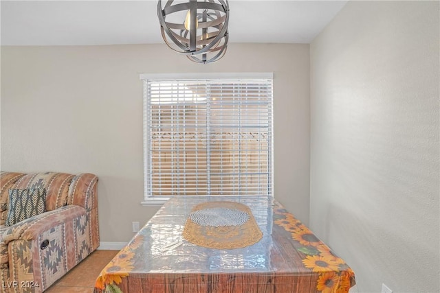 tiled dining room featuring a notable chandelier