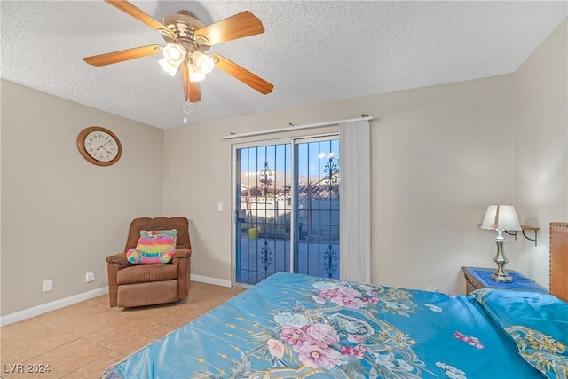 tiled bedroom with a textured ceiling, access to outside, and ceiling fan