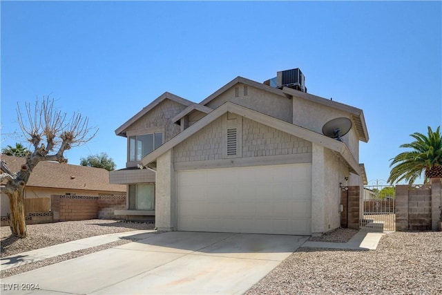 view of front of property with central air condition unit and a garage