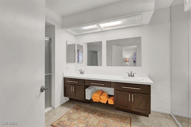 bathroom featuring vanity and an enclosed shower