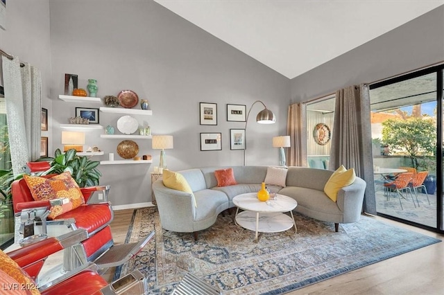 living room with wood-type flooring and high vaulted ceiling