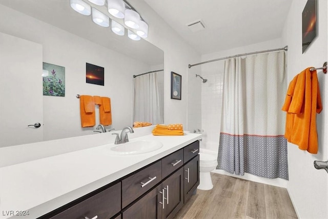 full bathroom featuring toilet, vanity, shower / bath combination with curtain, and hardwood / wood-style flooring