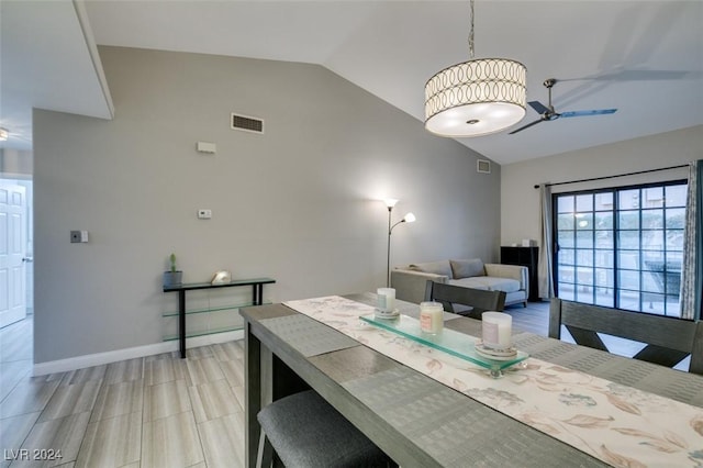 dining room with ceiling fan, lofted ceiling, and light wood-type flooring