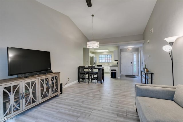 living room with light hardwood / wood-style floors and lofted ceiling