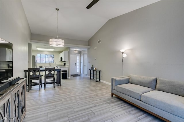 living room with light hardwood / wood-style floors and lofted ceiling