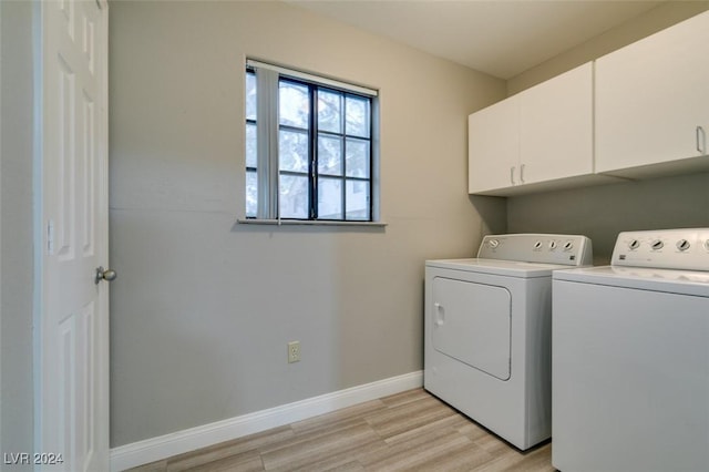 washroom with cabinets, independent washer and dryer, and light hardwood / wood-style floors