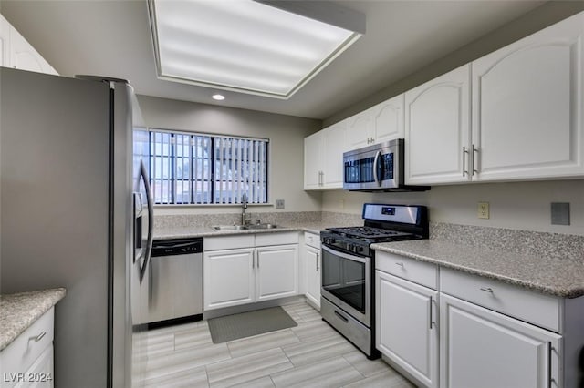 kitchen featuring white cabinets, sink, and appliances with stainless steel finishes