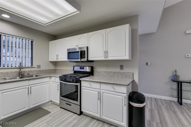 kitchen featuring white cabinetry, sink, and stainless steel appliances