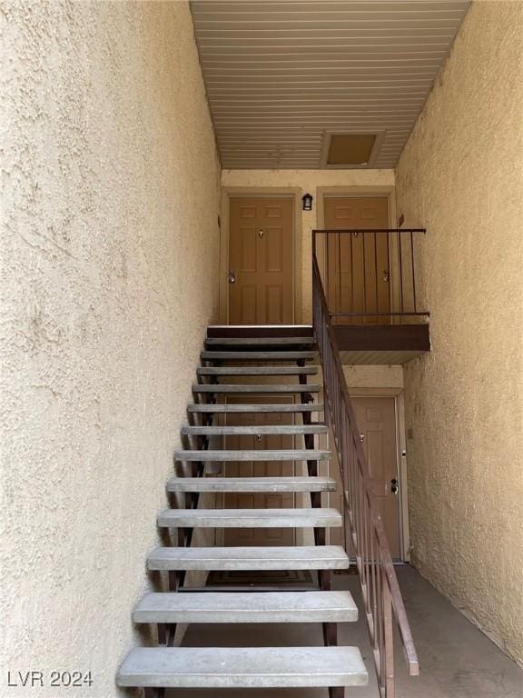 staircase with concrete flooring