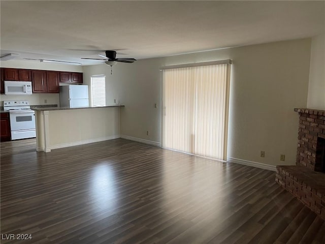 unfurnished living room featuring ceiling fan, a fireplace, and dark wood-type flooring