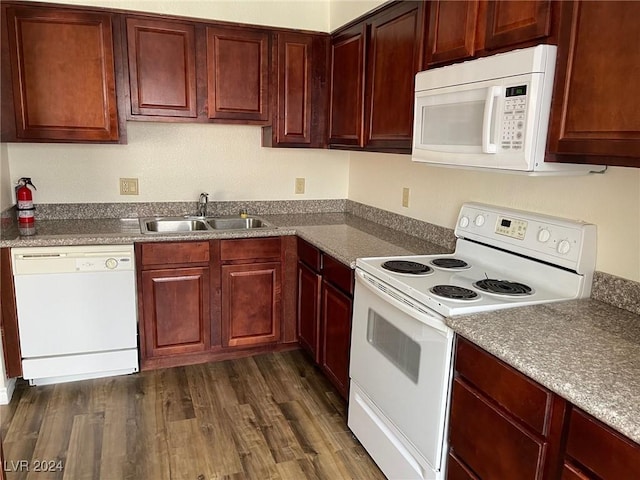 kitchen featuring dark hardwood / wood-style floors, white appliances, and sink