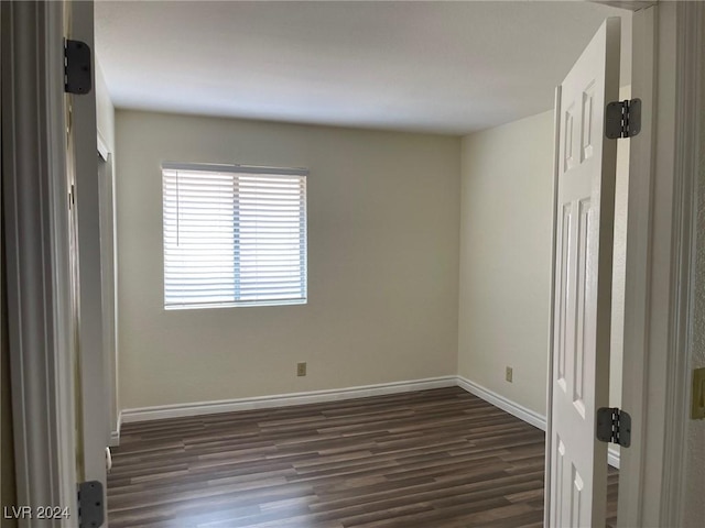 empty room featuring dark hardwood / wood-style flooring