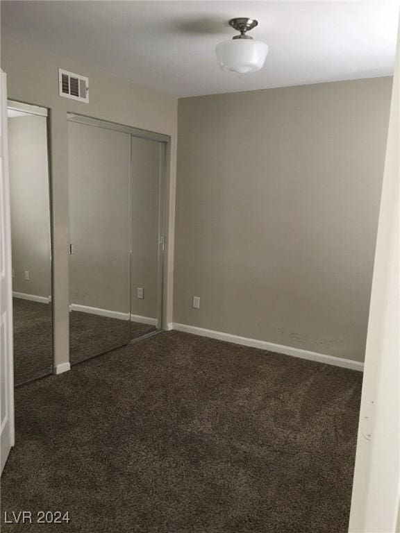 unfurnished bedroom featuring dark carpet