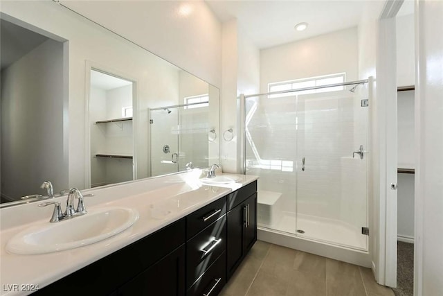 bathroom featuring tile patterned floors, vanity, and walk in shower