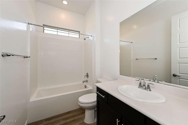 full bathroom with vanity, shower / bath combination, hardwood / wood-style flooring, and toilet