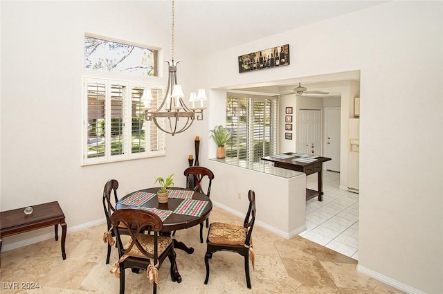 dining area featuring ceiling fan with notable chandelier and light tile patterned floors