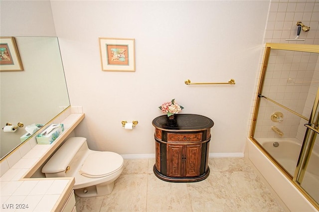 bathroom with tile patterned floors, toilet, and bath / shower combo with glass door