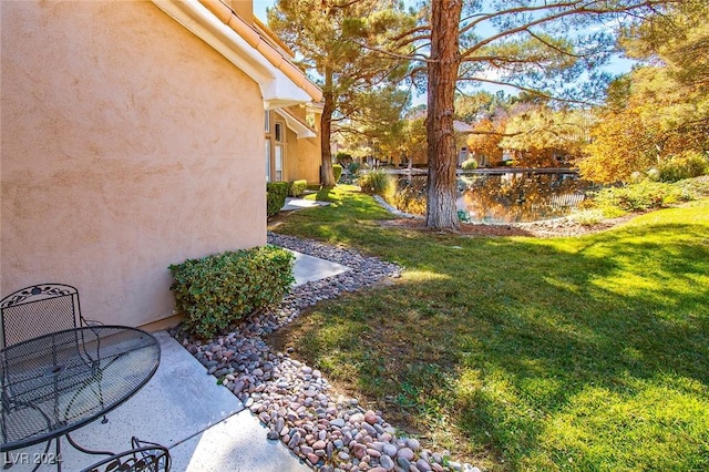 view of yard featuring a patio and a water view