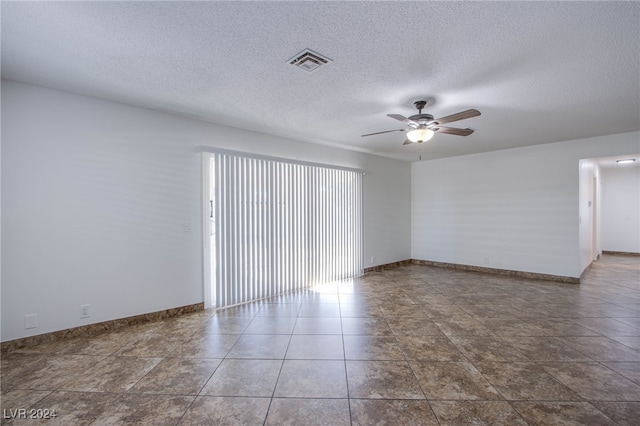 empty room featuring a textured ceiling and ceiling fan