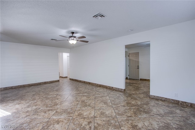 spare room with ceiling fan and a textured ceiling