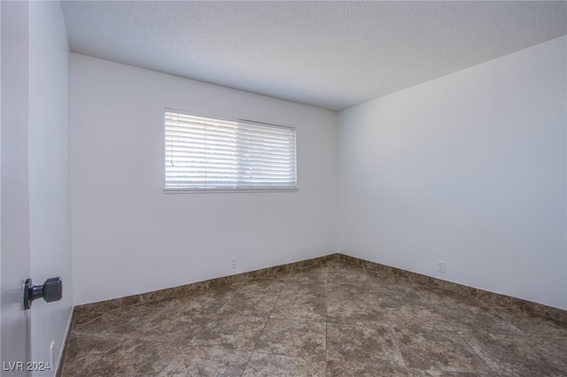 spare room featuring a textured ceiling