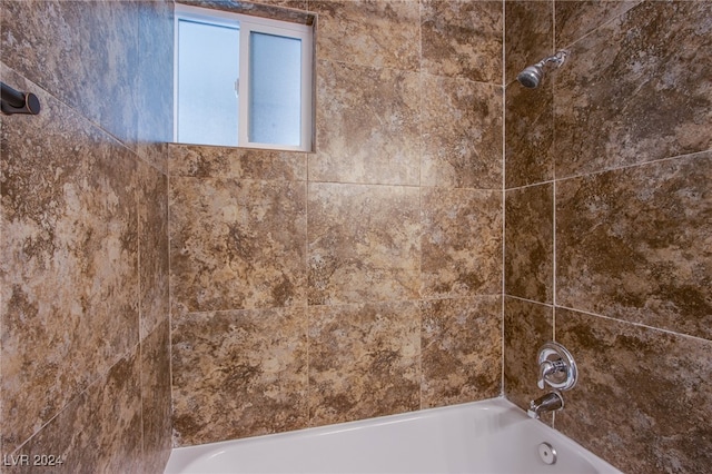 room details featuring tiled shower / bath