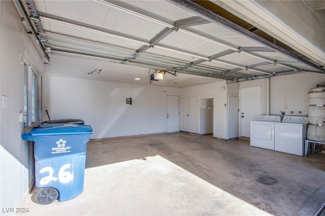 garage featuring separate washer and dryer and a garage door opener