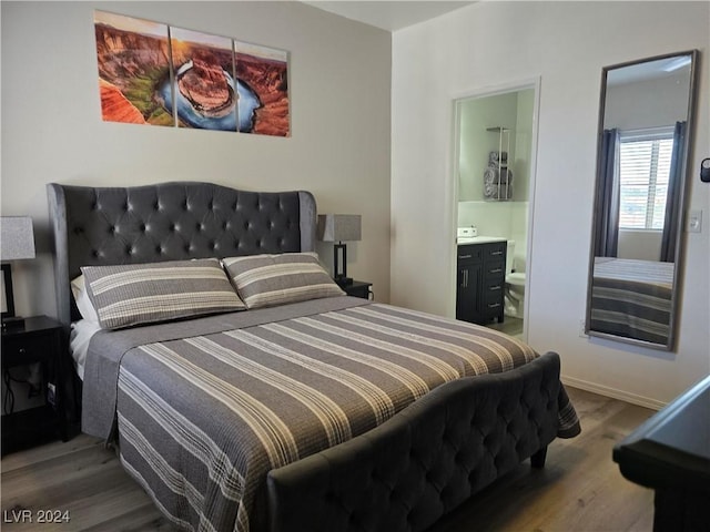 bedroom featuring ensuite bath and wood-type flooring