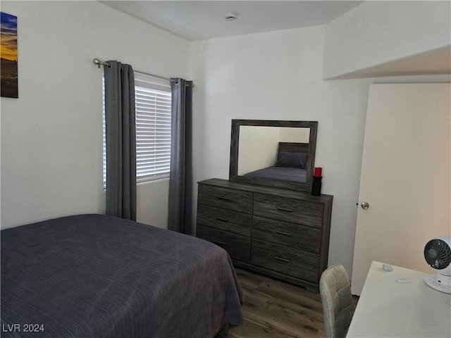 bedroom with dark hardwood / wood-style floors