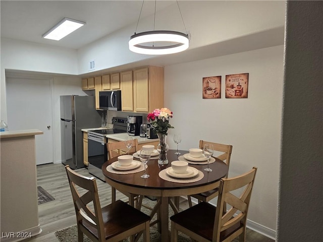 dining area with light wood-type flooring