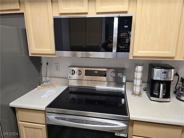 kitchen with light brown cabinetry and stainless steel appliances