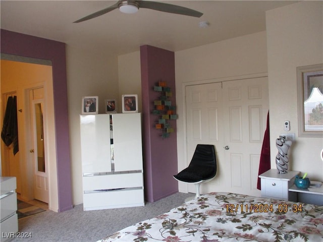 bedroom featuring ceiling fan, light colored carpet, and a closet