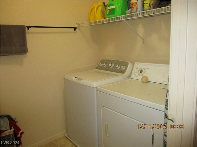 laundry room with independent washer and dryer and light tile patterned floors