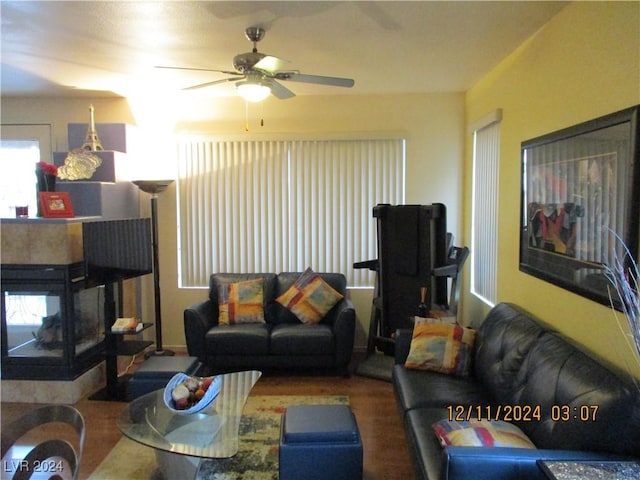 living room with hardwood / wood-style flooring and ceiling fan