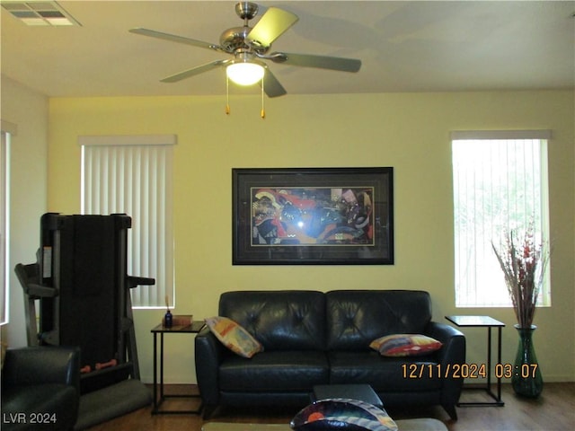 living room featuring ceiling fan and hardwood / wood-style flooring