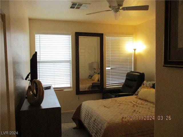 bedroom with carpet flooring, ceiling fan, and multiple windows