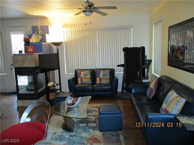 living room with ceiling fan and dark hardwood / wood-style flooring