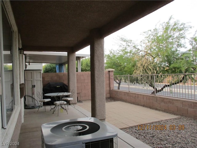 view of patio / terrace featuring a grill and cooling unit