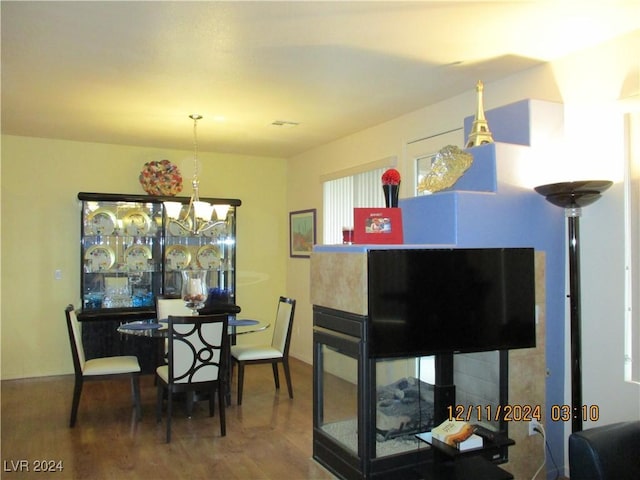 dining room with an inviting chandelier and hardwood / wood-style flooring