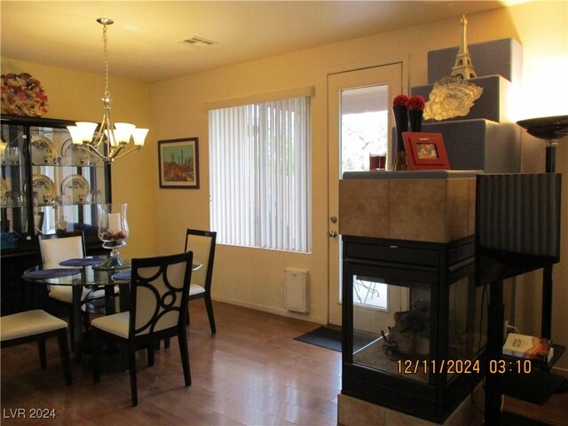 dining room with hardwood / wood-style flooring and an inviting chandelier