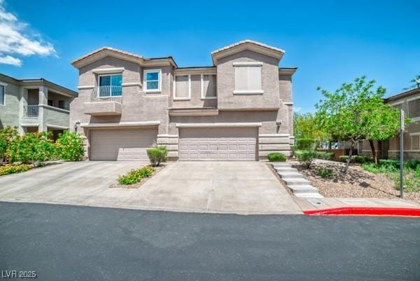 view of front facade with a garage, stucco siding, and concrete driveway
