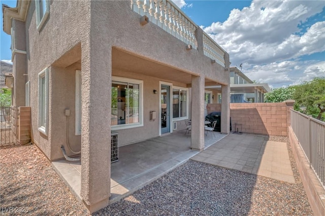 back of house with a patio area, stucco siding, and fence