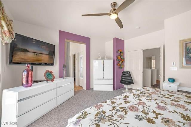 bedroom featuring a ceiling fan and light colored carpet