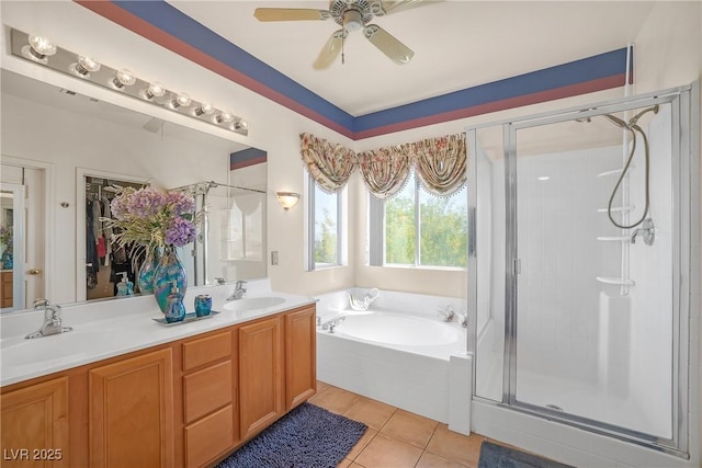 full bath featuring a garden tub, a sink, a stall shower, and tile patterned floors