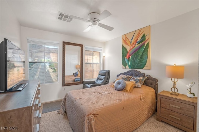 carpeted bedroom featuring a ceiling fan, baseboards, and visible vents